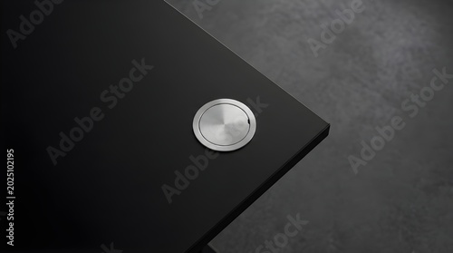 Silver coin resting on dark textured surface with soft lighting