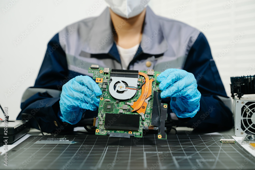 Obraz premium Electronics Technician Soldering Laptop Motherboard Circuit in Workshop