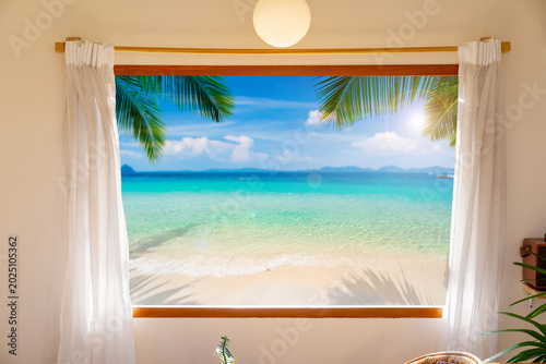 Relaxing morning view of a Paradise Island and modern beach house interior view from a cozy hotel room window with white curtains and palm trees.