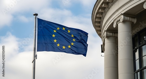 European union flag flying against cloudy sky and classical architecture