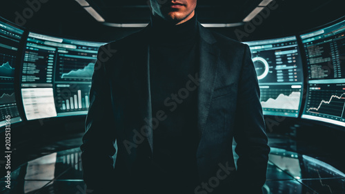 Powerful Business Executive in Black Suit Standing Confidently Inside Futuristic Data Command Center Surrounded by Multiple Curved Screens Displaying Financial Charts and Global Analytics.