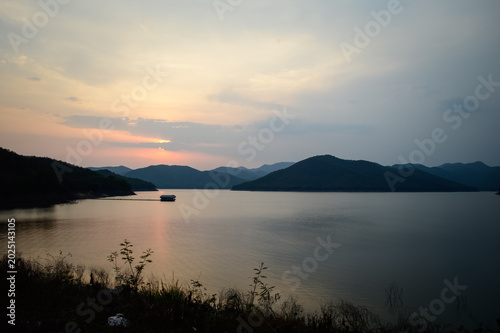 Mountain views and a summer sunset at Mae Kuang Udom Thara Dam, Chiang Mai Province, Northern Thailand.