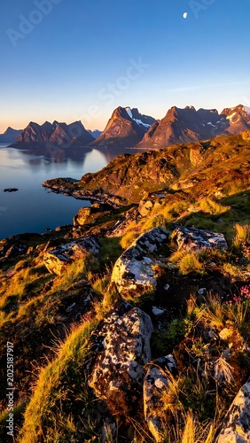 A serene mountainous landscape with a calm lake at sunrise