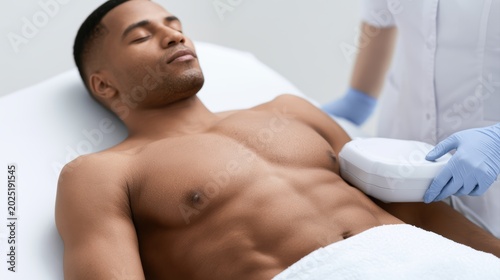 Cryolipolysis fat reduction treatment on male abdomen in beauty clinic, modern cosmetic procedure scene
