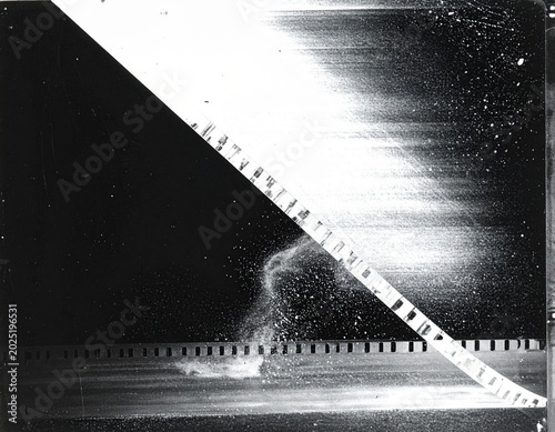 Cinematic film strip with water splash on textured black background high contrast