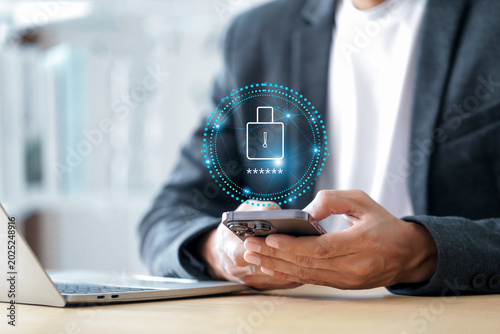 Cuadro en lienzo Cybersecurity protects Login , Businessman using mobile phone to log in securely with user interface screen data protection, privacy, authentication, and online security