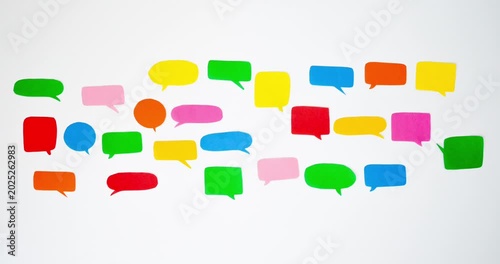 Pattern of a colorful speech bubbles on a white background. Communication and social connections concept. Looped 4K stop motion animation