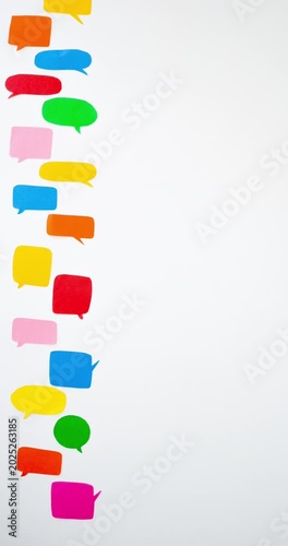 Pattern of a colorful speech bubbles on a white background with a place for text. Communication and social connections concept. Vertical looped 4K stop motion animation