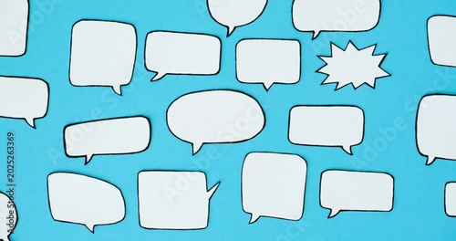Pattern of black and white speech bubbles on a blue background. Communication and social connections concept. Looped 4K stop motion animation