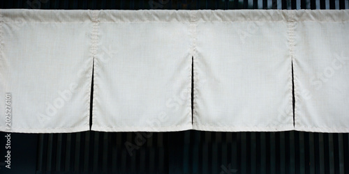 White Japanese noren curtain hanging at traditional shop entrance, Kyoto, Japan