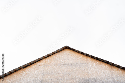 Foto Roof gable of an unfinished house with plywood wall against sky