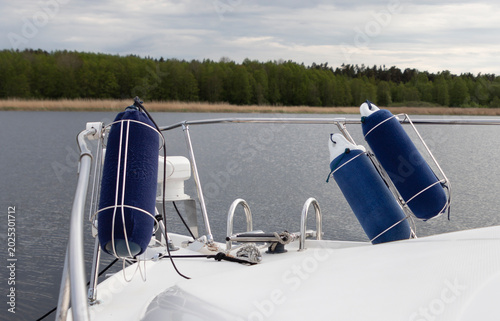 Fotografía Blue Boat Fenders Hanging on a Yacht Railing
