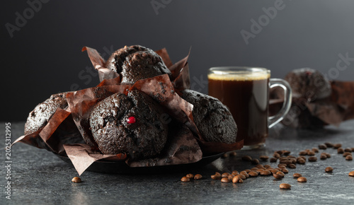 Dark chocolate muffins and cup of black coffee.
