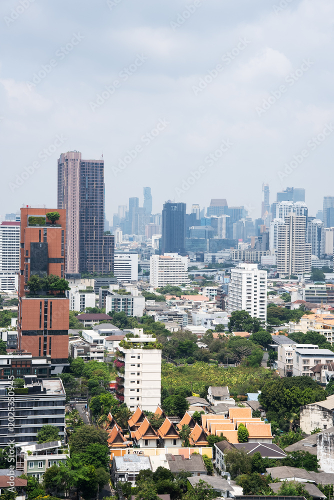 Naklejka premium Dense Bangkok Cityscape With Modern Buildings And Skyline, Vertical Urban View With Copy Space And Metropolitan Development Concept