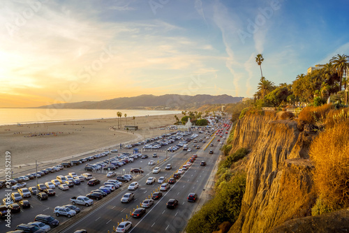 Cuadro en lienzo Santa Monica Beach in Los Angeles, California, at sunset, with Pacific coastline, traffic, and a lively tourist boardwalk atmosphere