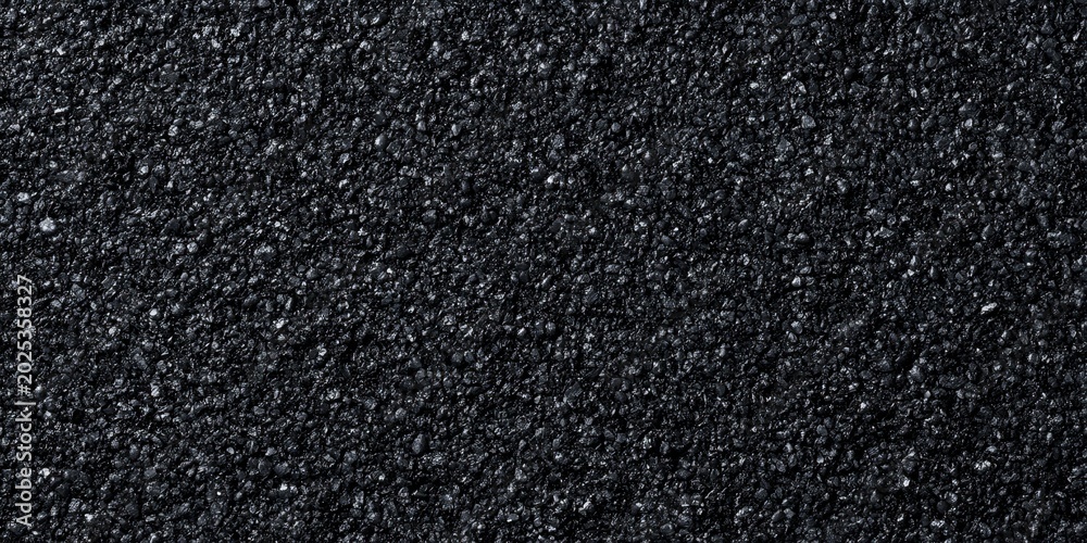 Fototapeta premium Asphalt pavement showing rough texture on dark street
