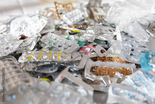 Close up of a large pile of empty aluminum blister packs from pills and medication ready for recycling.