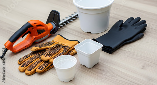 Gardener's tools and gloves laid out on a wooden surface for planting.