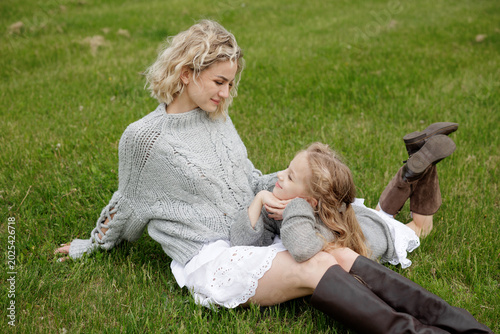 Mother and Daughter Enjoying a Tender Moment on the Grass