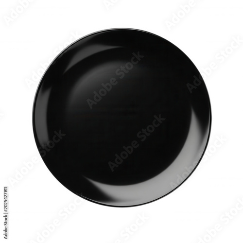 A single, empty, circular black ceramic plate viewed from directly above, isolated against a solid black background, with soft rim lighting