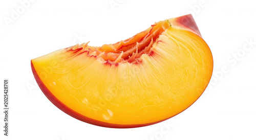 A single, fresh slice of a ripe peach with vibrant yellow and orange flesh, isolated against a solid black background