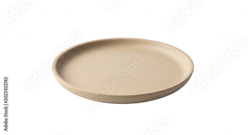 A single, round, matte beige ceramic plate centered on a solid black background, viewed from a slightly elevated angle