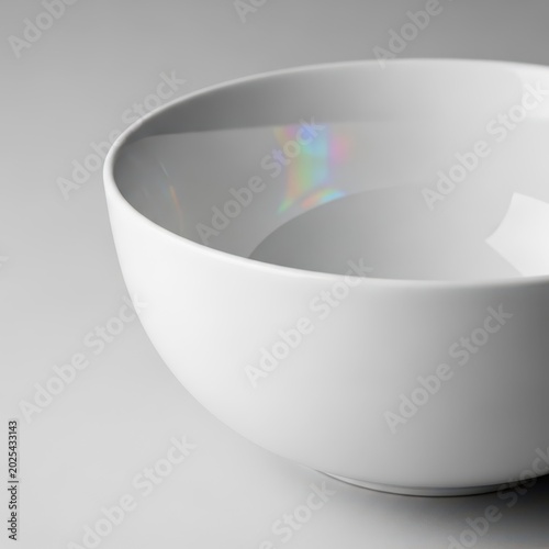 Luxurious closeup of a brilliant white porcelain bowl featuring a smooth, reflective surface and an exquisite, high-gloss ceramic glaze finish, upscale, white, sophisticated
