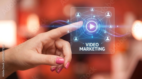 Woman's finger pointing at video marketing concept with play button and people icons