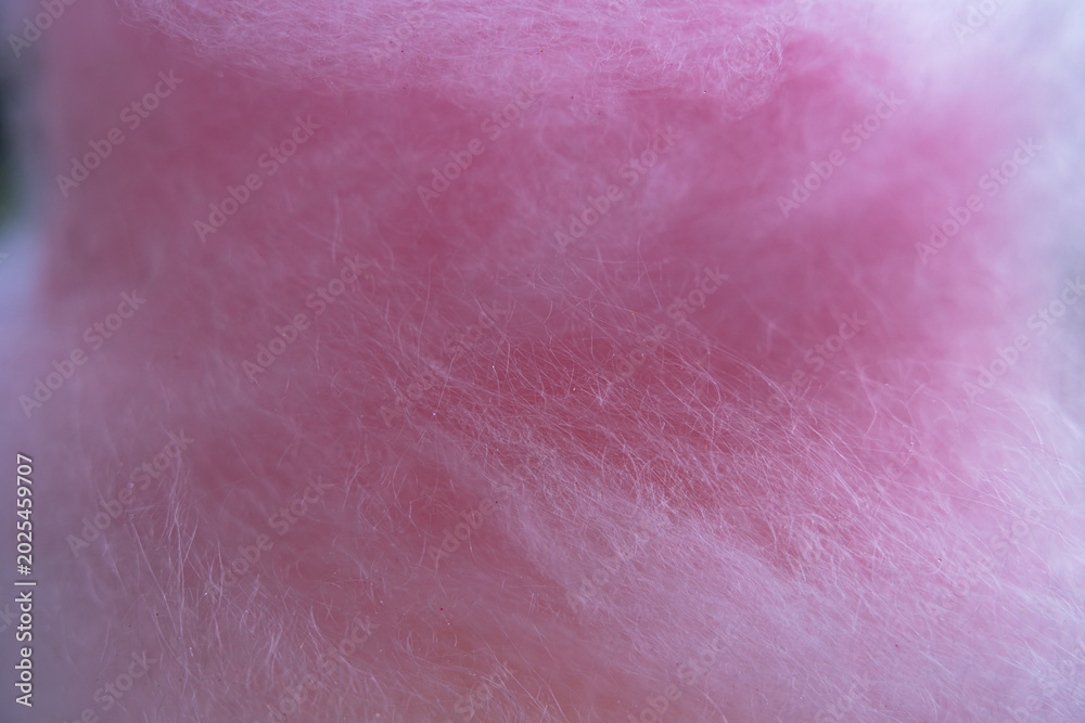 Fototapeta premium Macro texture of pink cotton candy sugar threads background close up