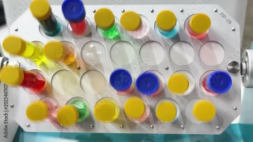 Colorful test tubes in a lab show various liquids used for experiments in a science facility