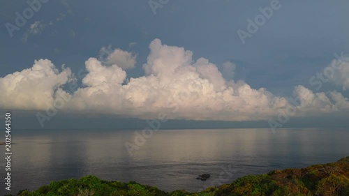 The background for evening scene in summer vacation concept with the nature of tranquil ocean horizon under a bright blue sky and white clouds	