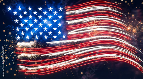 Vibrant american flag design created with brilliant light trails and glowing fireworks in the night sky