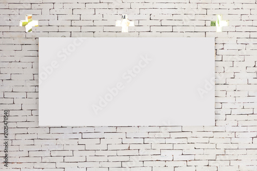 Blank frame hanging on an old brick wall inside a textured room