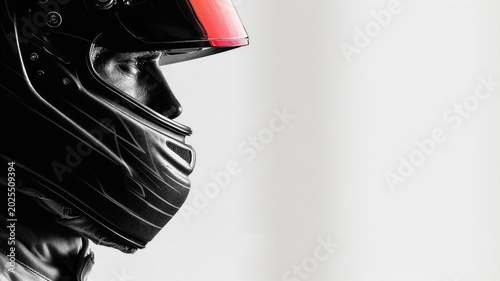 Side profile racing driver helmet portrait with minimalist white background.