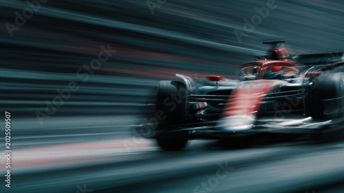 Motion-blur Formula racing car speeding on racetrack.