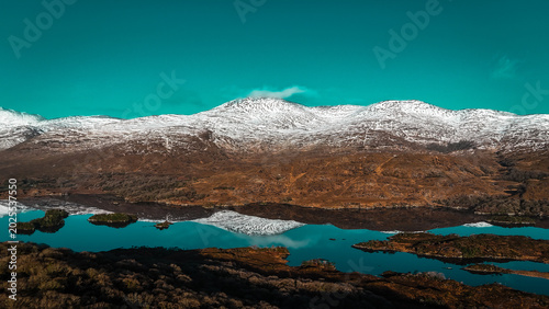 Drone shot aerial view of the ring of Kerry in Ireland in winter and snowcapped mountains 