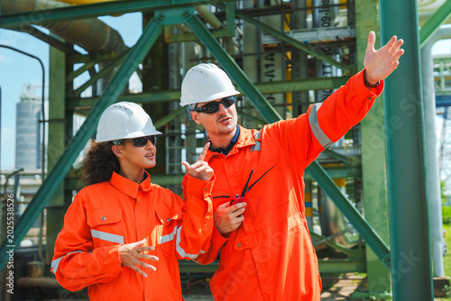 Photos Oil and gas refinery in petroleum industry with inspection engineer, industrial