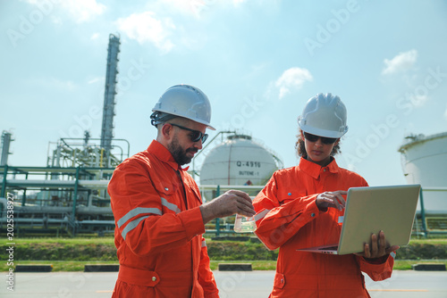Photos Oil and gas refinery in petroleum industry with inspection engineer, industrial