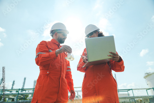 Tablou pe pânză Oil and gas refinery in petroleum industry with inspection engineer, industrial
