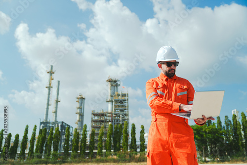 Quadro em tela Oil and gas refinery in petroleum industry with inspection engineer, industrial