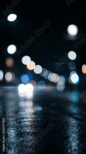 City street at night, blurred lights, wet pavement, urban landscape, nighttime scene