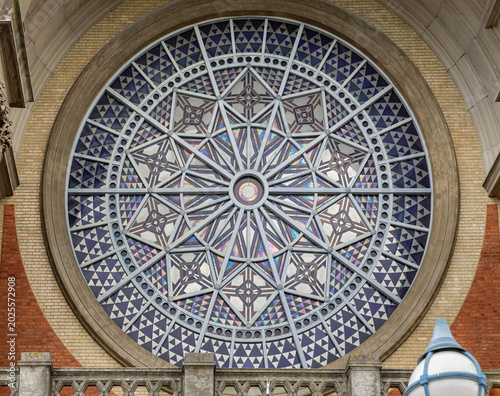The massive Rose Window serves as the breathtaking focal point of Alexandra Palace South facade, its intricate geometric tracery and stained glass motifs drawing the eye inward. This architectural mas