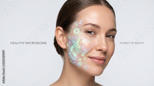 Young woman with clear skin smiling and highlighting facial microbiome  