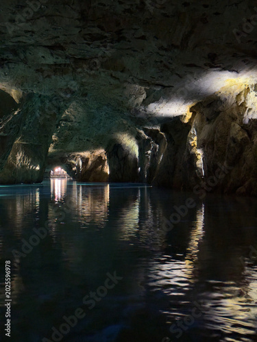 Saint-Léonard, Valais, Switzerland - May 02, 2026: Crystal Clear Turquoise Waters and Rocky Cave Walls of the Underground Lake at Lac Souterrain