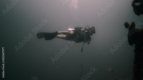 Konstfotografi Scuba diver exploring deep murky water, enjoying underwater adventure