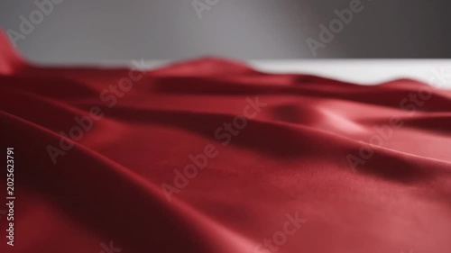Luxurious red fabric flowing elegantly with soft light and gentle textures, creating a sense of calm