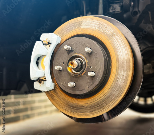 Fotografie Car ventilated front brake disc with caliper