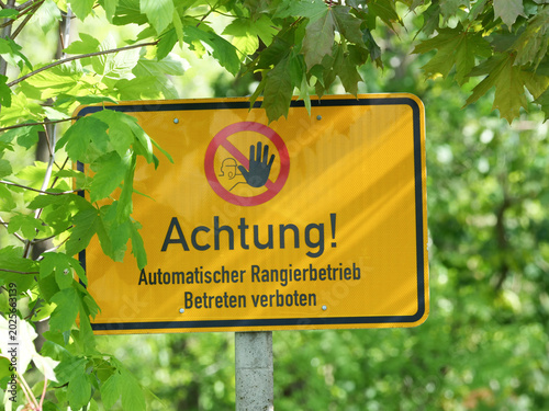 Konstfotografi The image shows a warning sign that reads: “Caution! Automatic shunting in progress
