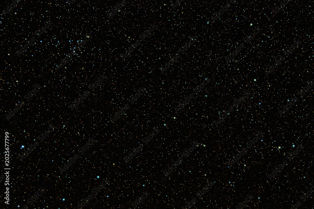 Fototapeta premium Dense starfield in deep outer space with glowing celestial lights
