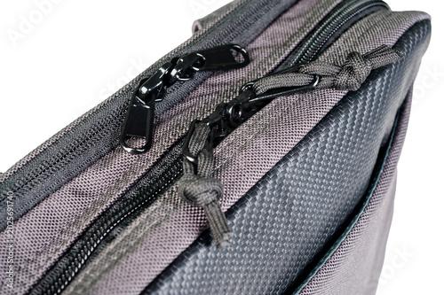 A small grey bag with a long adjustable handle.